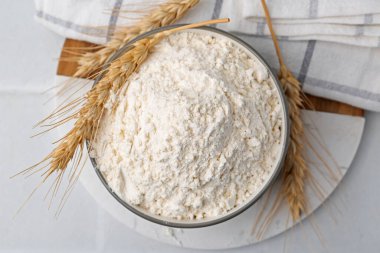 Beyaz masa üzerinde buğday unu ve çiviler, üst manzara.