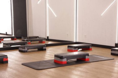 Fitness stüdyosunda birçok basamak var. Spor malzemeleri.