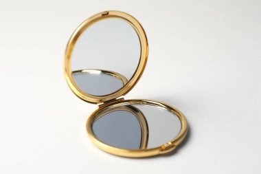 Açık gri arkaplanda cep aynasını aç, yakın plan