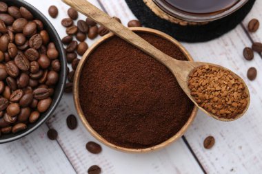 Farklı türde kahve ve fasulyeler açık ahşap masada, düz yerde.