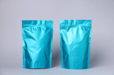 Açık gri arka planda fermuarlı stand-up kesesi. Tasarım için model