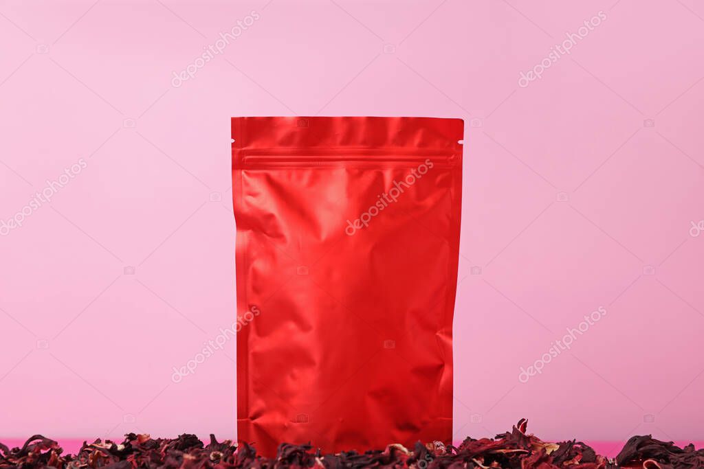 One zipper stand-up pouch with dry flowers on pink background. Mockup for design