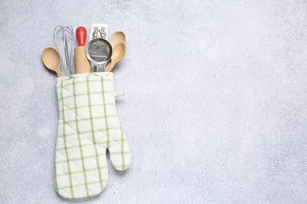 Farklı mutfak aletleri fırın eldivenlerinde, ışık masasında, üst tarafta. Metin için boşluk