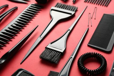 Kırmızı arka planda farklı kuaför araçları, yakın plan