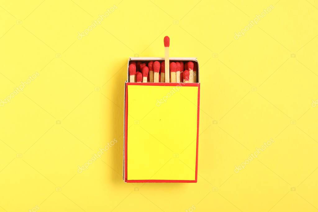 Matches in box on yellow background, top view. Mockup for design