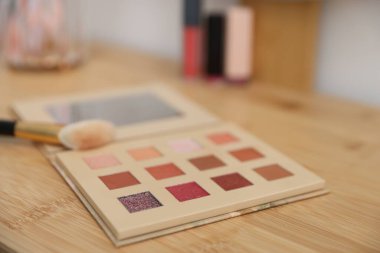 İçerideki ahşap tuvalet masasında fırçalı göz falı, yakın plan. Kozmetik ürünleri