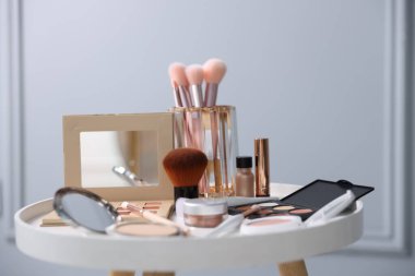 Beyaz masada farklı makyaj ürünleri, kapalı masa, yakın çekim.