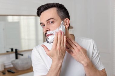 yakışıklı adam banyoda tıraş köpük uygulama