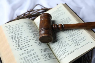 Yargıç tokmağı, dikenli taç ve beyaz kumaş üzerine İncil, yakın plan.