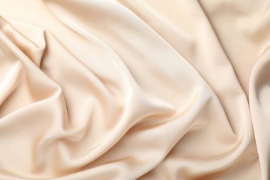 Arkaplan olarak buruşuk bej ipek kumaş, üst görünüm