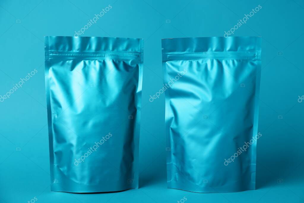 Zipper stand-up pouches on light blue background. Mockup for design