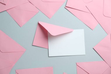 Boş davetiye kartı ve gri arka planda zarflar. Tasarım için boşluk