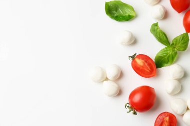 Beyaz arka planda lezzetli mozarella topları, domates ve fesleğen. Metin için boşluk