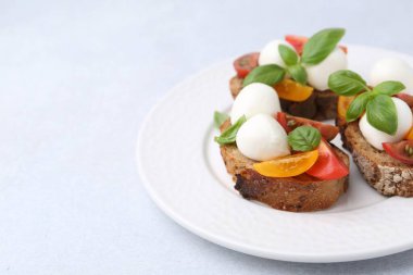 Mozarella peynirli, domatesli ve fesleğenli lezzetli sandviçler, yakın plan. Metin için boşluk