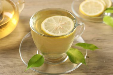 Limonlu yeşil çay ve ahşap masa yaprakları, yakın çekim