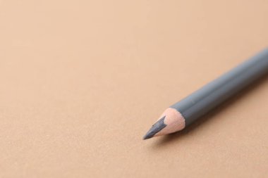 Bej arka planda gri kaş kalemi, yakın plan. Metin için boşluk