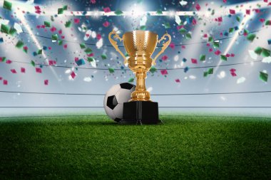 Futbol şampiyonası. Stadyumda düşen konfeti altında parlak altın kupa ve futbol topu