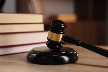 Yargıç tokmağı ve ahşap masa üzerindeki kitaplar, seçici odaklanma.