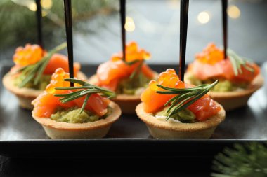 Lezzetli kanepeler ve Noel dekorasyonu masada, yakın plan.