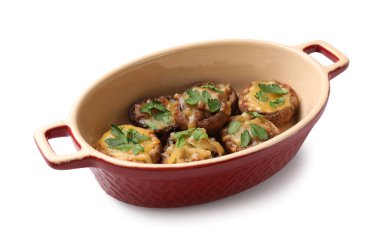 Eritilmiş peynir ve maydanozla doldurulmuş lezzetli mantarlar beyaz tencereye izole edilmiş.