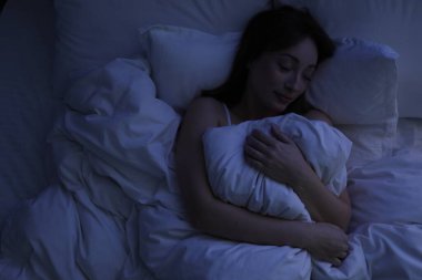 Evdeki yatakta uyuyan güzel bir kadın.