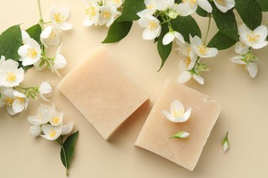 Bej arka planda sabun ve yasemin çiçekleri, düz yatış