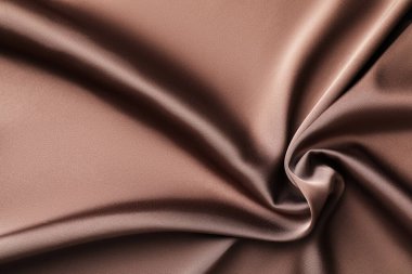 Arkaplan olarak buruşuk açık kahverengi ipek kumaş, üst görünüm