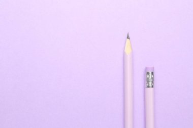 Menekşe arka planda iki grafit kalem, düz. Metin için boşluk