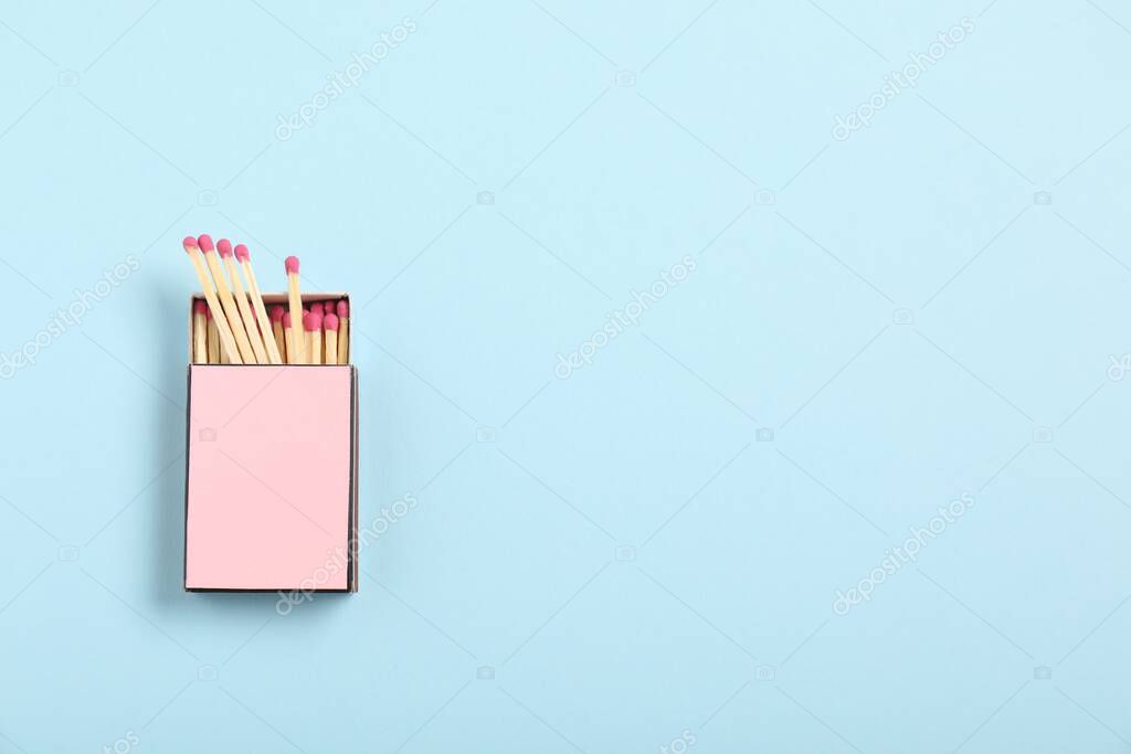 Matches in box on light blue background, top view. Mockup for design
