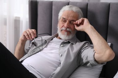 Evde yatağında göz yorgunluğundan muzdarip son sınıf öğrencisi.