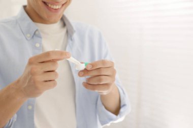 Adam kontakt lensleri evden çıkartıyor, yakın plan. Metin için boşluk