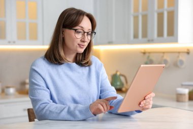 Modern tabletli kadın mutfaktaki beyaz mermer masada.