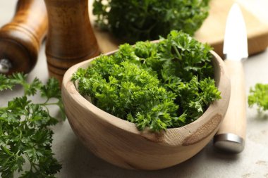 Taze maydanoz, baharatlar ve bıçak ışık masasında, yakın plan.