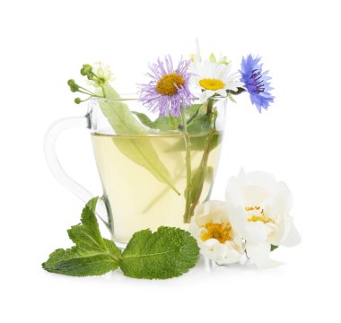 Cam bardakta aromatik bitki çayı, beyaz bardakta izole edilmiş nane ve çiçekler.