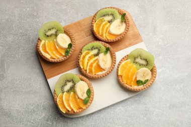 Meyveli tart ve nane, gri desenli masa, üst manzara. Tatlı nefis.