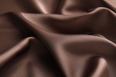 Arkaplan olarak buruşuk açık kahverengi ipek kumaş, yakın plan