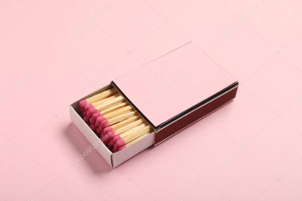 Matches in box on pink background, closeup. Mockup for design
