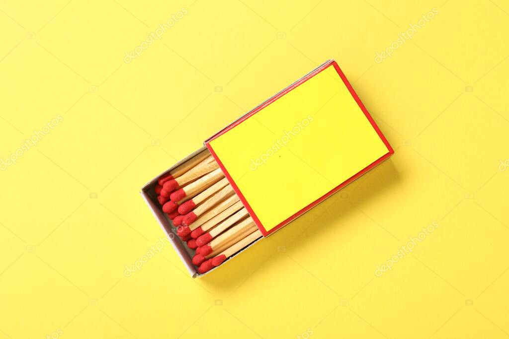 Matches in box on yellow background, top view. Mockup for design