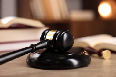 Yargıç tokmağı ve ahşap masa üzerindeki kitaplar, seçici odaklanma.