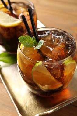 Küba libre kokteylini ahşap masada nane şekeri ile tazeliyorum.