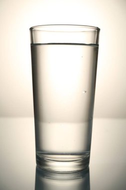 Gri gradyan arkaplana karşı ayna masasında taze su