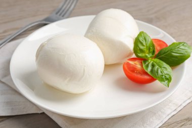 Lezzetli mozzarella peynirli toplar, domates ve fesleğen, yakın plan.