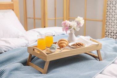 Nefis bir kahvaltı tepsisi ve kapalı bir odada çiçekler.