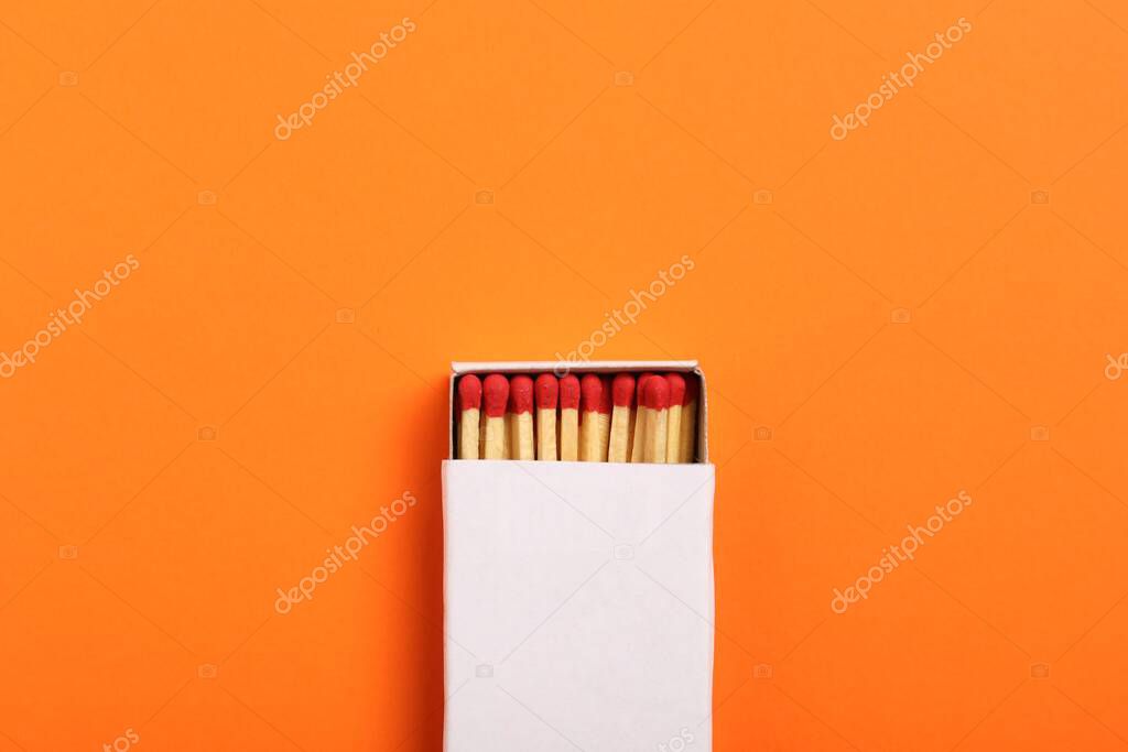 Matches in box on orange background, top view. Mockup for design
