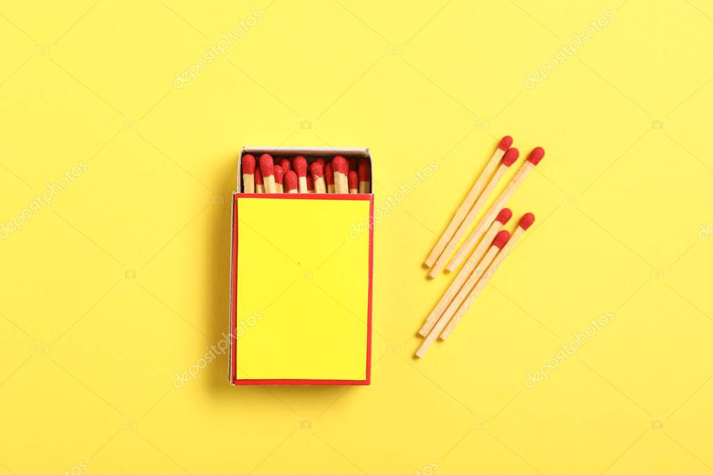 Matches and box on yellow background, flat lay. Mockup for design