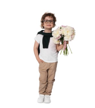 Beyaz arka planda bir buket güzel şakayığı olan sevimli küçük bir çocuk.