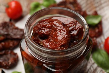 Lezzetli güneşte kurutulmuş domatesler ve taze sebzeler masada, yakın plan.