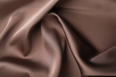 Arkaplan olarak buruşuk açık kahverengi ipek kumaş, üst görünüm