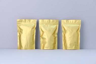 Açık gri arka planda fermuarlı stand-up kesesi. Tasarım için model