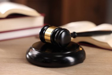 Yargıç tokmağı ve ahşap masa üzerindeki kitaplar, seçici odaklanma.